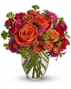 orange roses and red daisies in vase