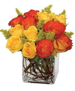 Orange and yellow blend together in this bright arrangement featuring roses and solidago. Perfect for fall or any occasion.