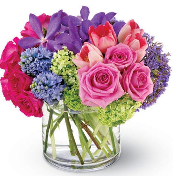 This beautiful spring bouquet created in a soft palette of purple, pink and green is like an oasis of calm sent to soothe a hectic life. A lovely addition to any decor. Send one to a special friend or treat yourself!