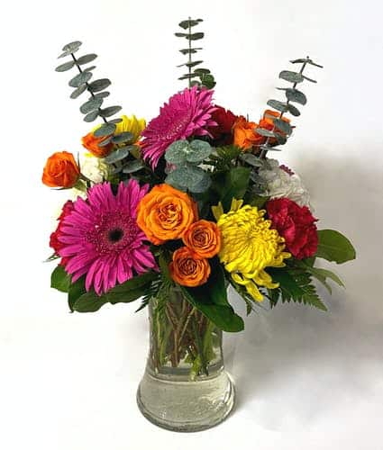  all around bright arrangement is stunning from every side. Beautiful hydrangea, gerbera daisies, spray roses, and fuji mums, are arranged together in a stunning arrangement. The pinks, oranges, yellows, and white in this arrangement will brighten up anyone's day. 