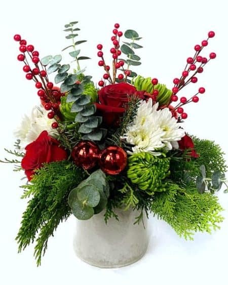 This arrangement is sure to make their heart grow three sizes. Red roses, green mums, and more make up this delightful arrangement.